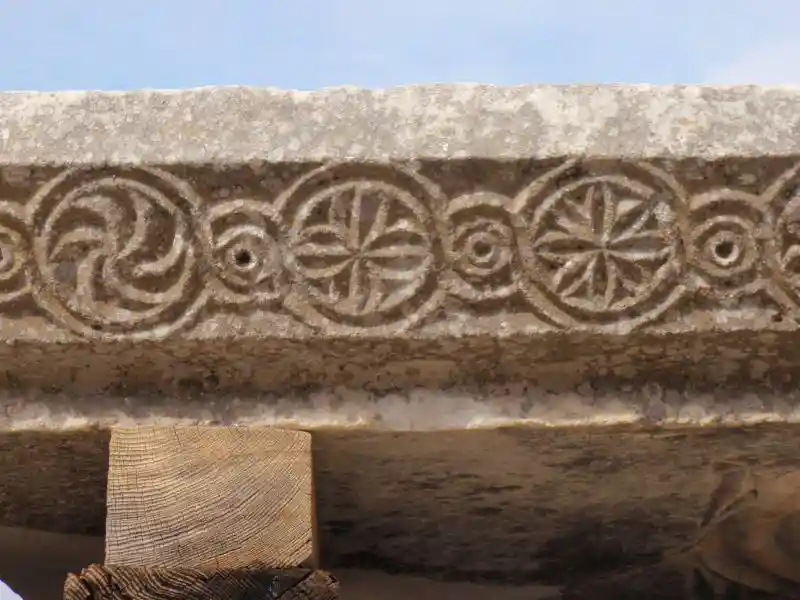 Different solar discs and solar crosses on pillar stone